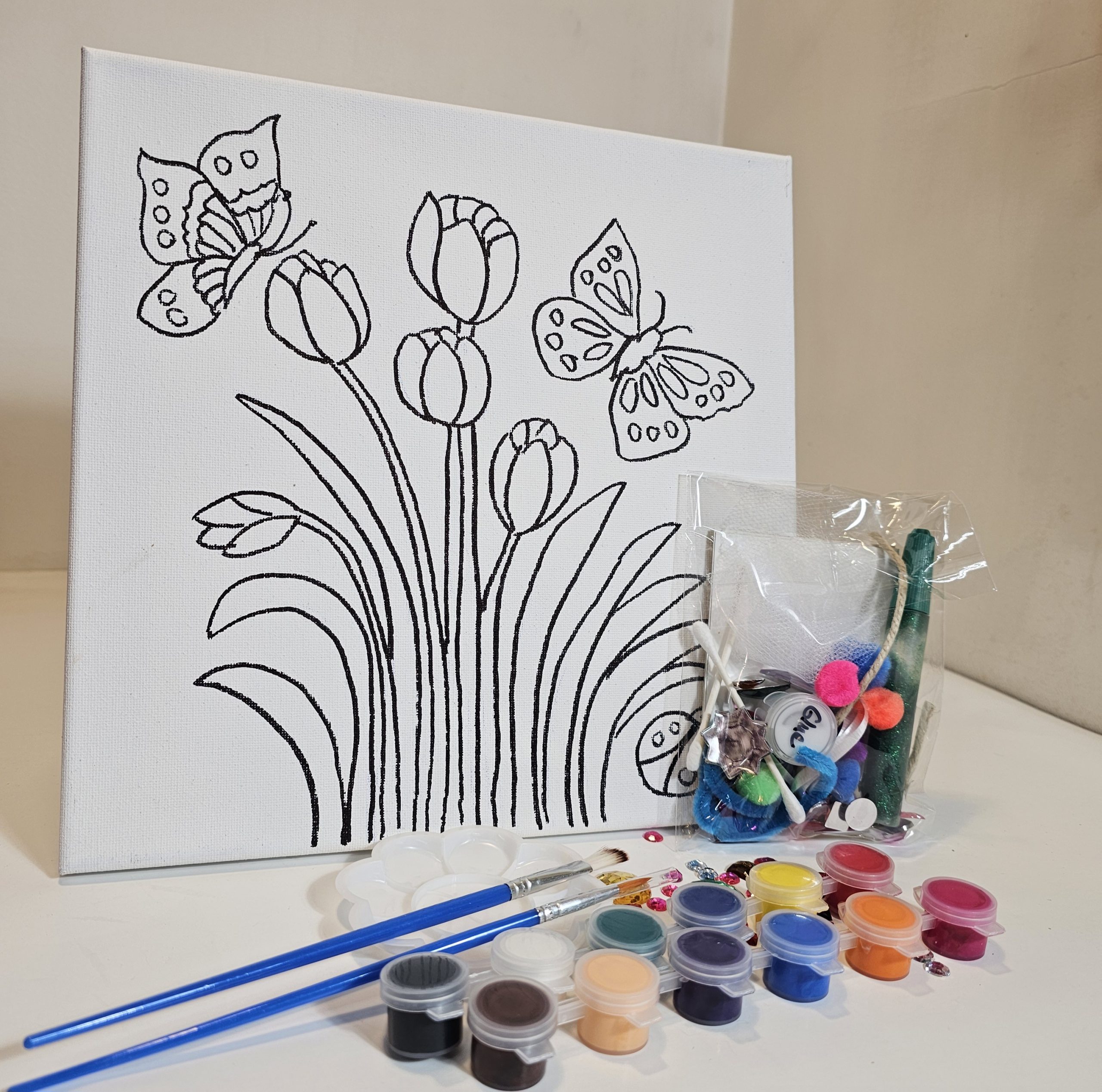 Kit with tulip canvas, paints, glue, and collage supplies