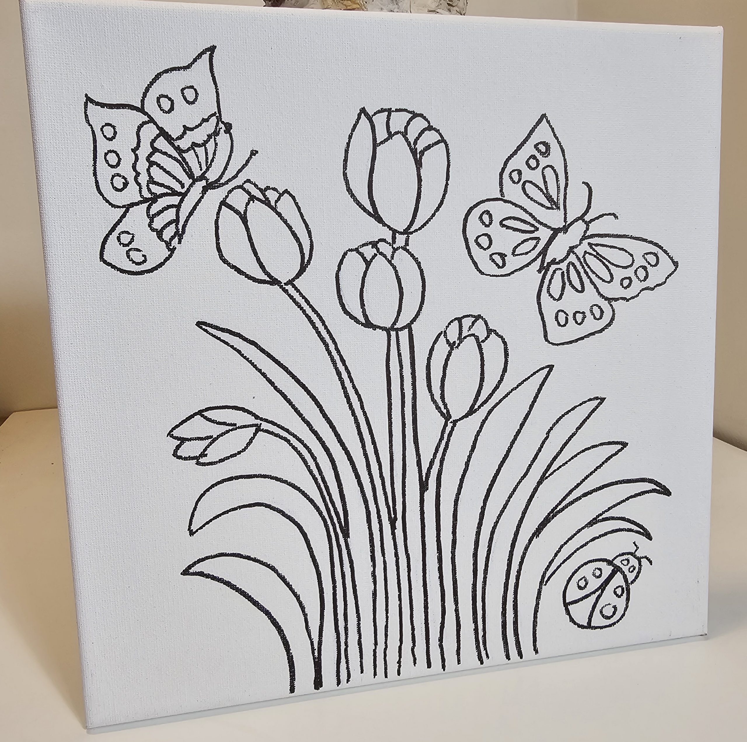 Tulip and butterfly canvas leaning on display
