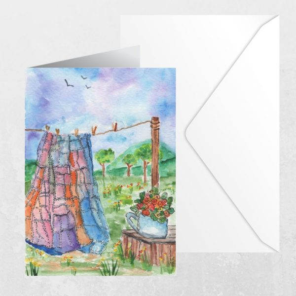 Watercolor greeting card with envelope featuring quilt on a clothesline and floral teapot