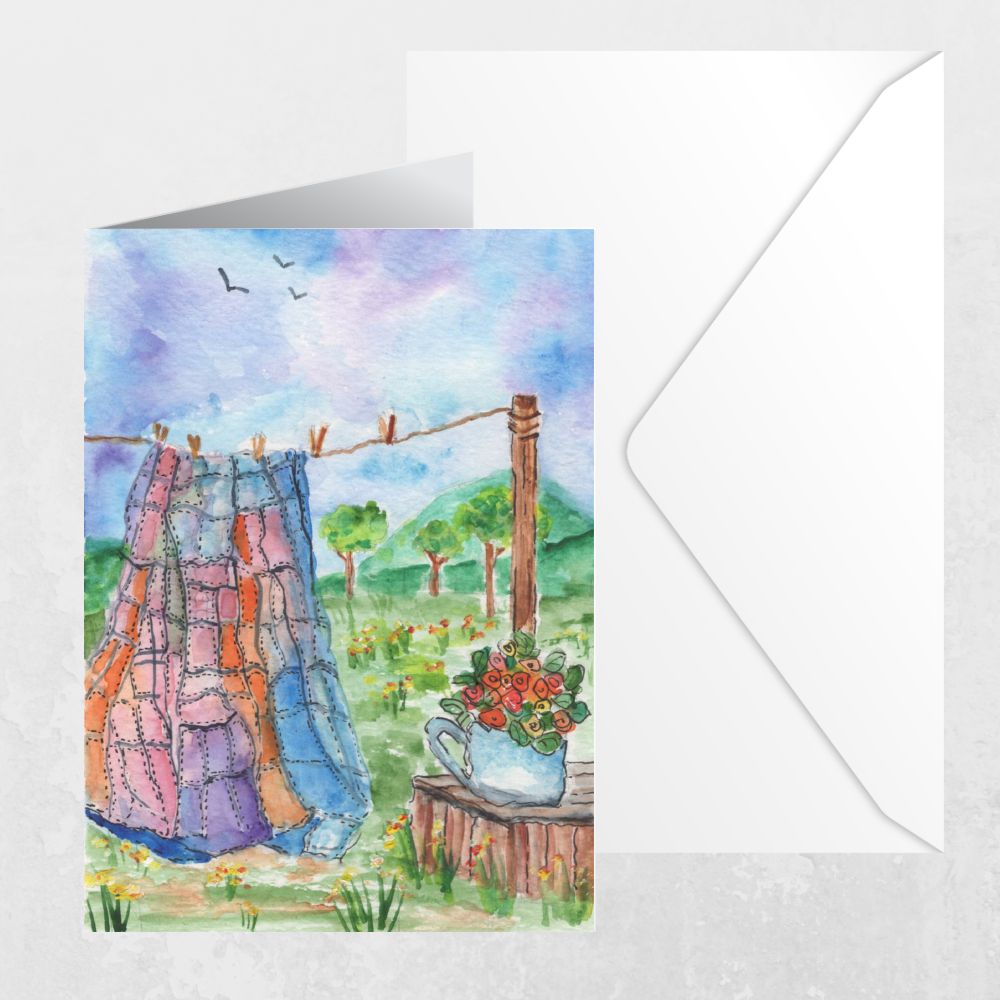 Watercolor greeting card with envelope featuring quilt on a clothesline and floral teapot