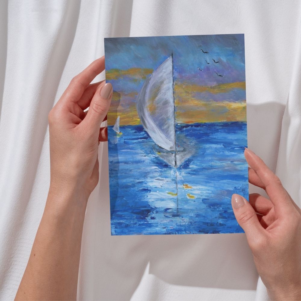 Woman holding a sailboat sunset greeting card