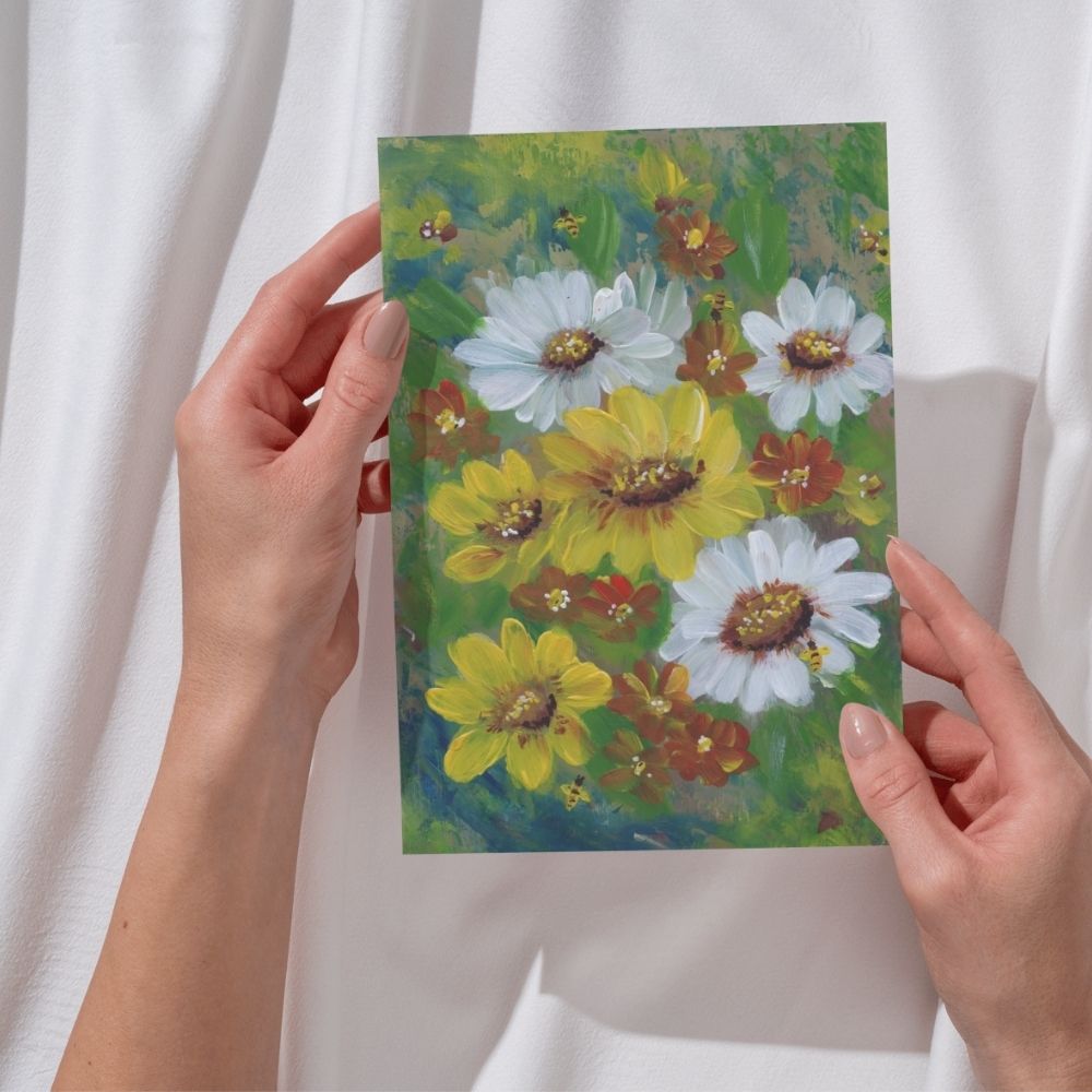 Woman holding a wildflower and bee greeting card