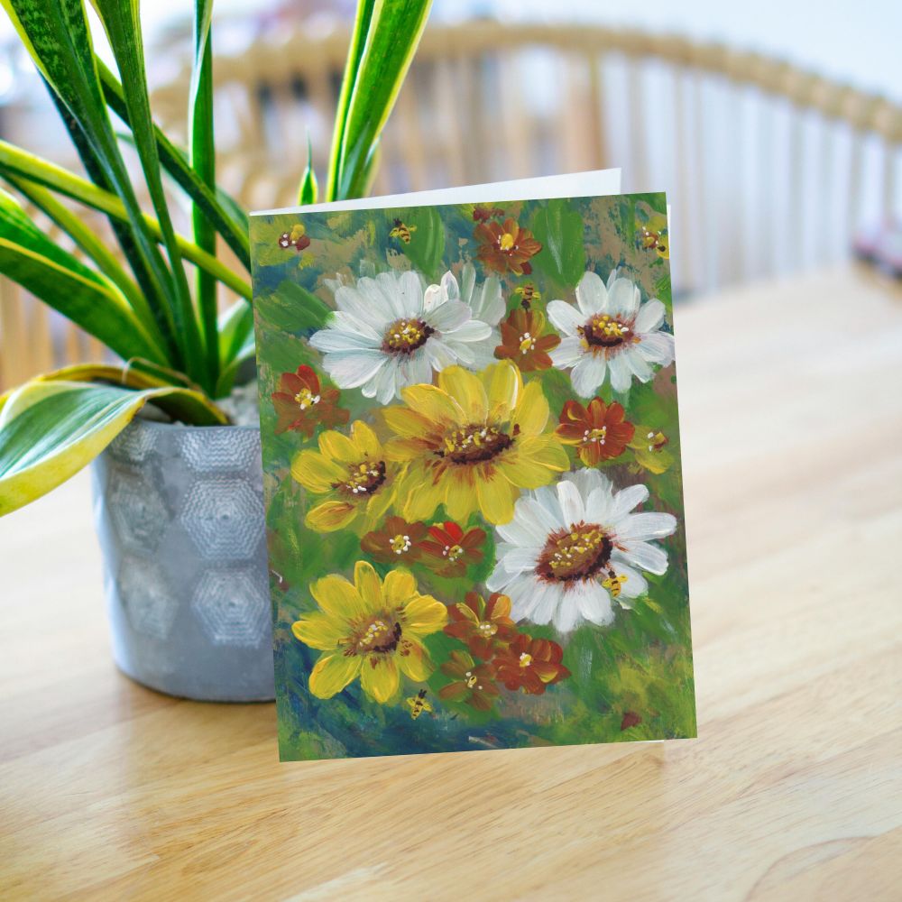 Greeting card leaning against a plant in a cozy lifestyle scene