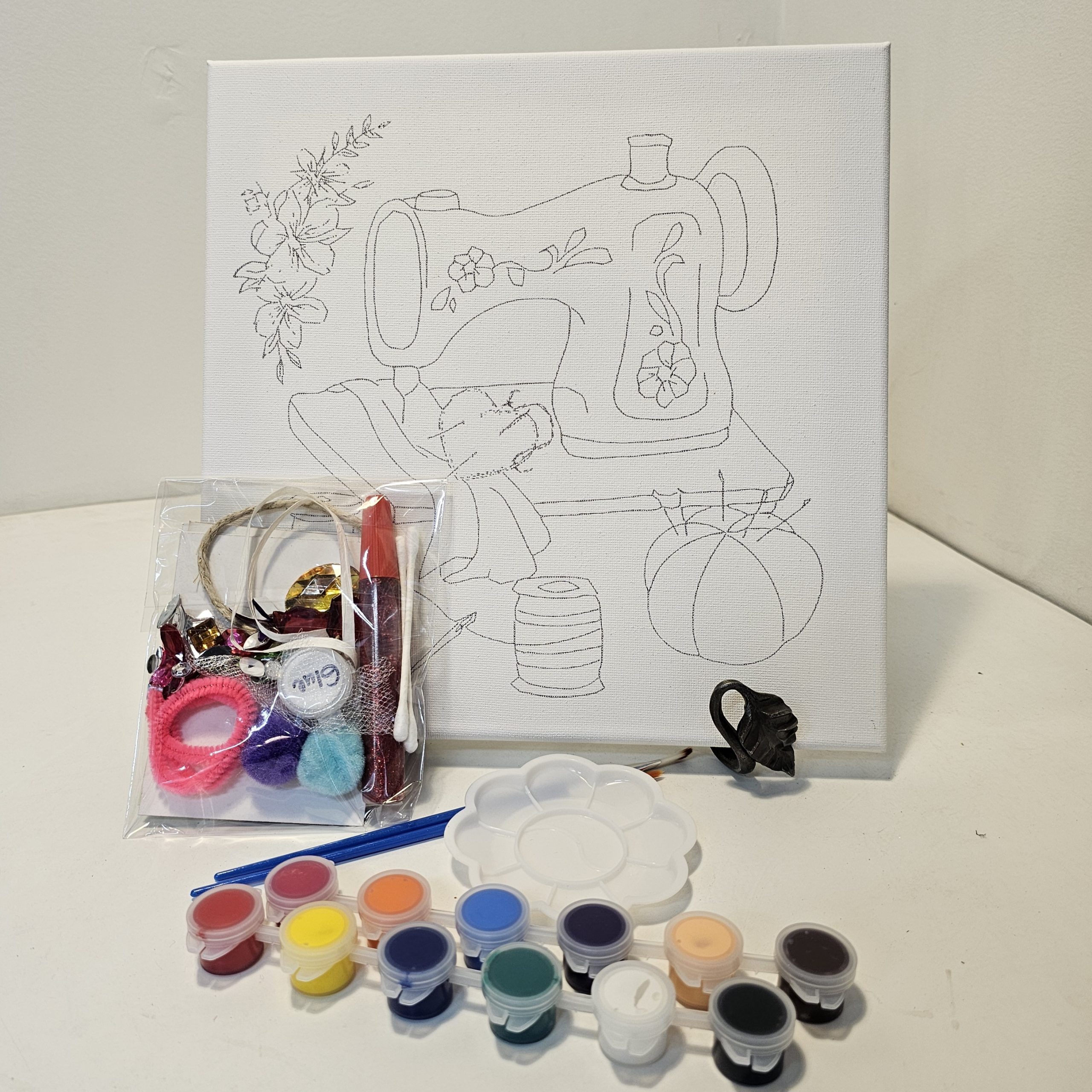 Sewing machine with heart canvas with all included supplies arranged around it